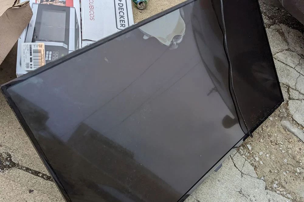 Flatscreen TV staged on concrete for Fred's TV recycling pickup in San Diego